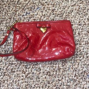 Small red heart coach hand clutch